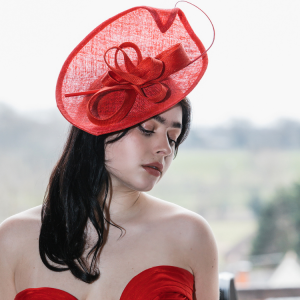 Red Sinamay Sculptural Hat with Bow and Quill Detail by Isabella Josie