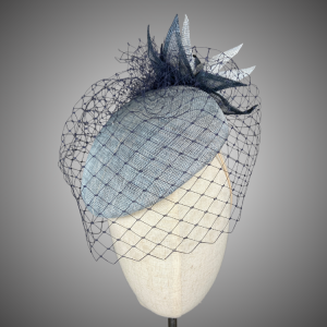 Sky Blue Slanted Brimless Occasion Hat with navy veiling